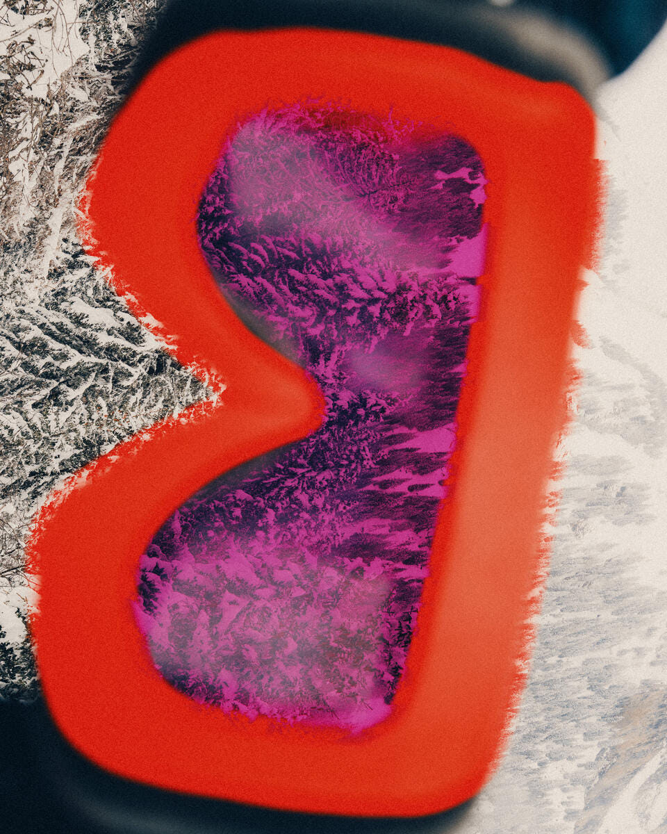A close-up of a red heart-shaped object with a textured purple and magenta interior, set against a snowy white and dark background.
