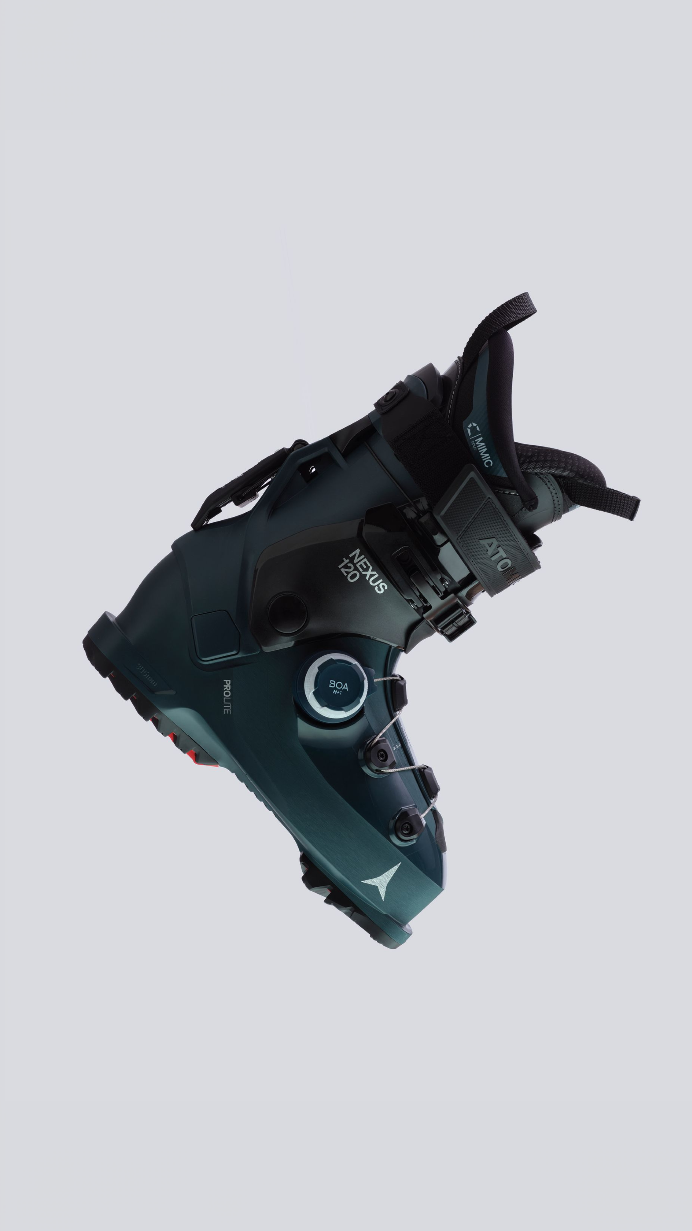 A single ski boot floating against a light gray background, shown at an angle to display its side and front features. The boot is dark teal with black buckles and straps, featuring white branding text including 'Mizuno' and 'ATX'.