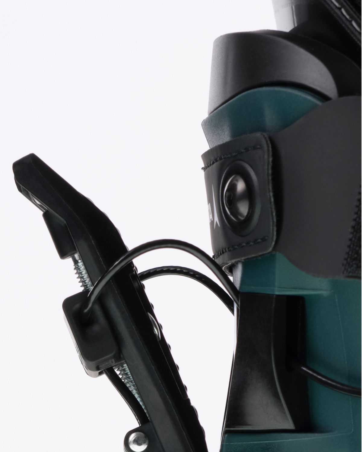 Close-up detail of a snowboard binding device with black plastic components and a dark teal metal frame against a light gray background.