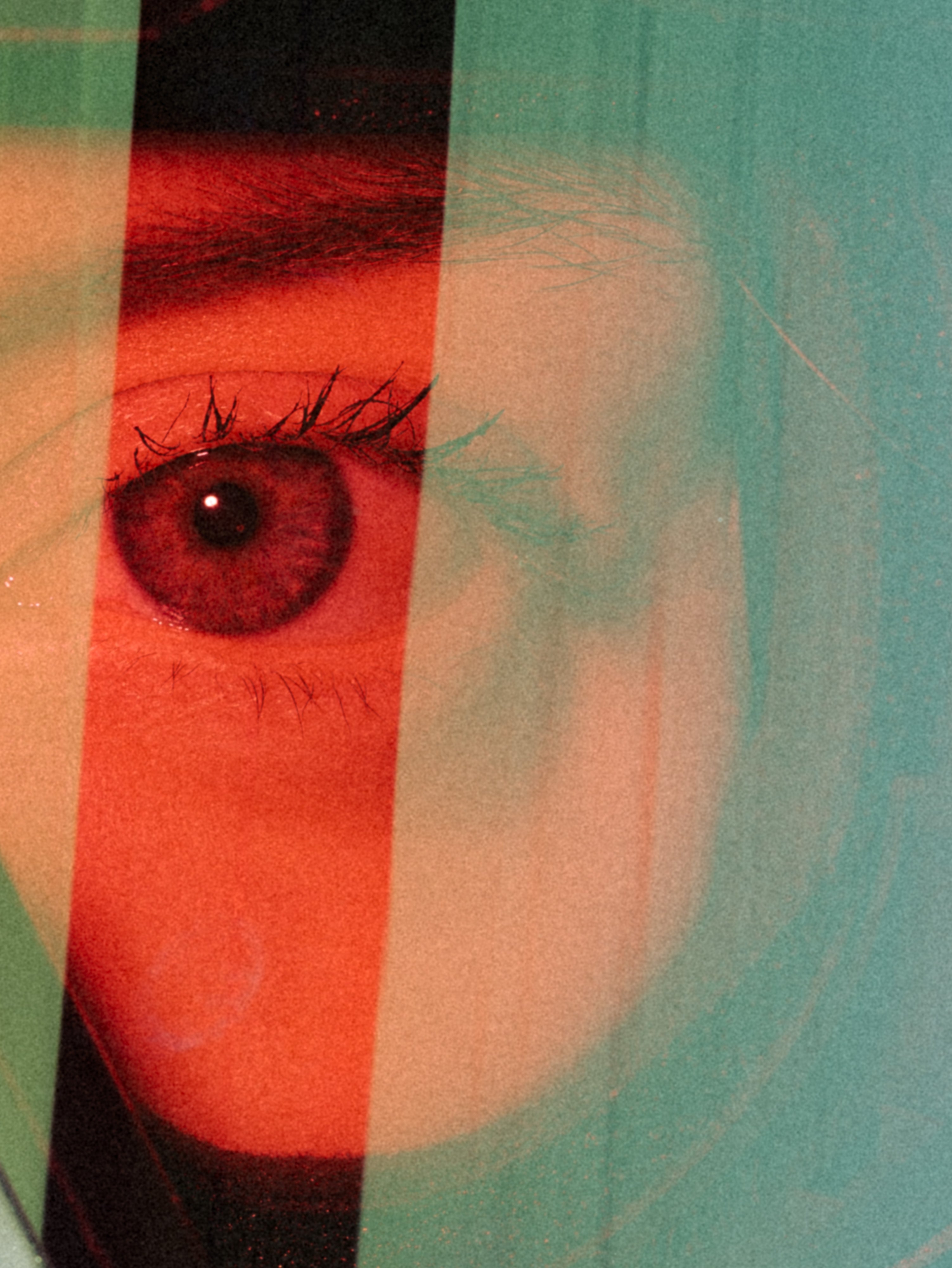 Close-up of Justine Blanachard's eye with dramatic red and teal color blocking and a blurred face overlay, creating a stylized, graphic look.