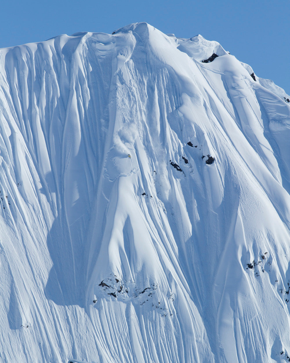 Daron Rahlves in the middle of a line in a steep mountain face. 
